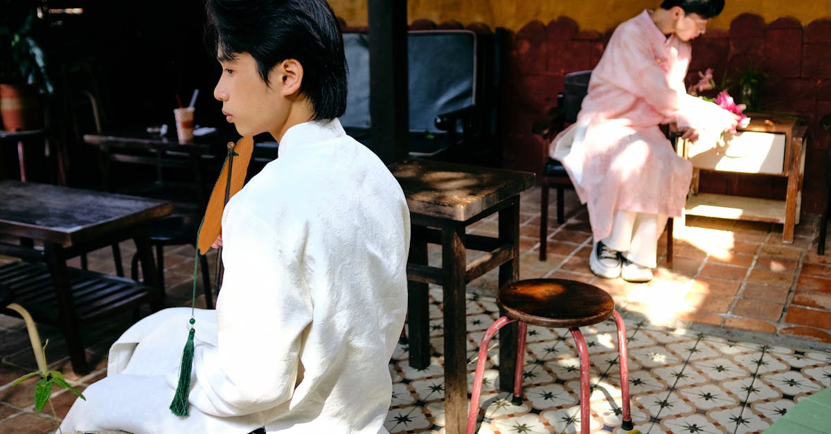 Two men wearing traditional Ao Dai in an outdoor setting in Bến Tre, Vietnam, capturing cultural elegance.