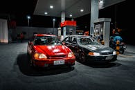 Nighttime Gas Station Scene with Two Cars