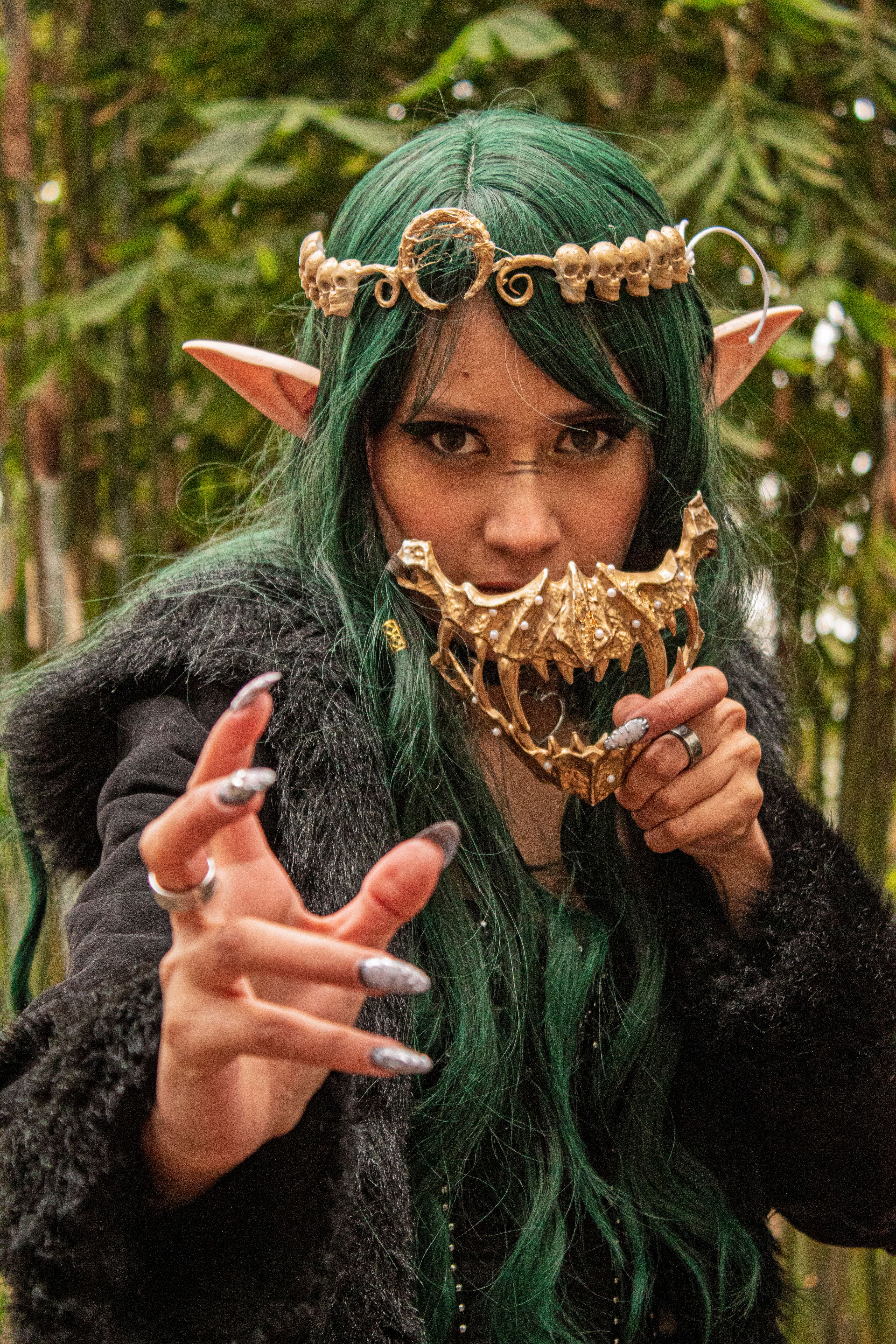 A captivating portrait of a mystical character with green hair and elf ears, set in an enchanted forest.
