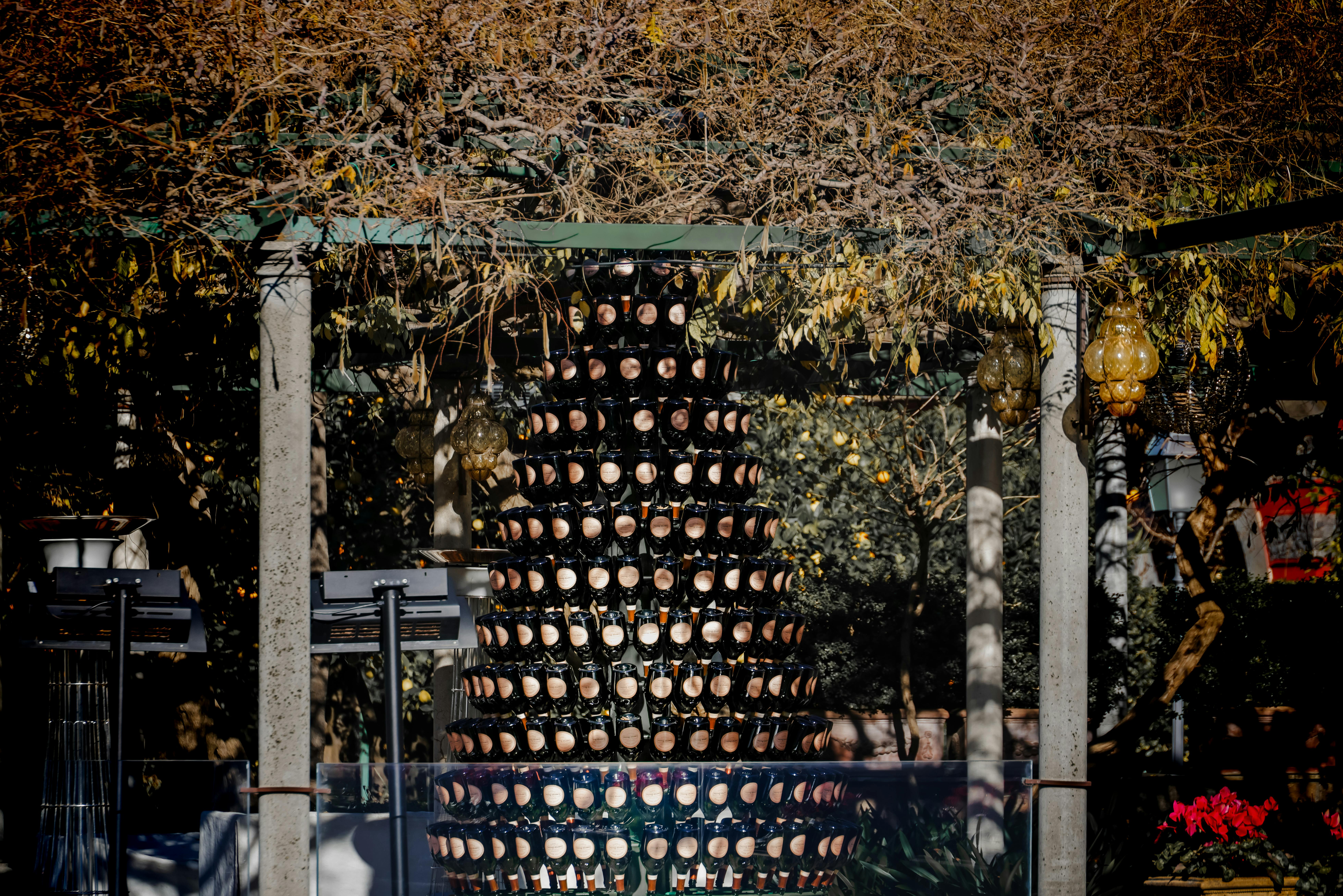 無料 秋の屋外にシャンパンボトルを積み重ねて作られた独創的な構造物。 写真素材