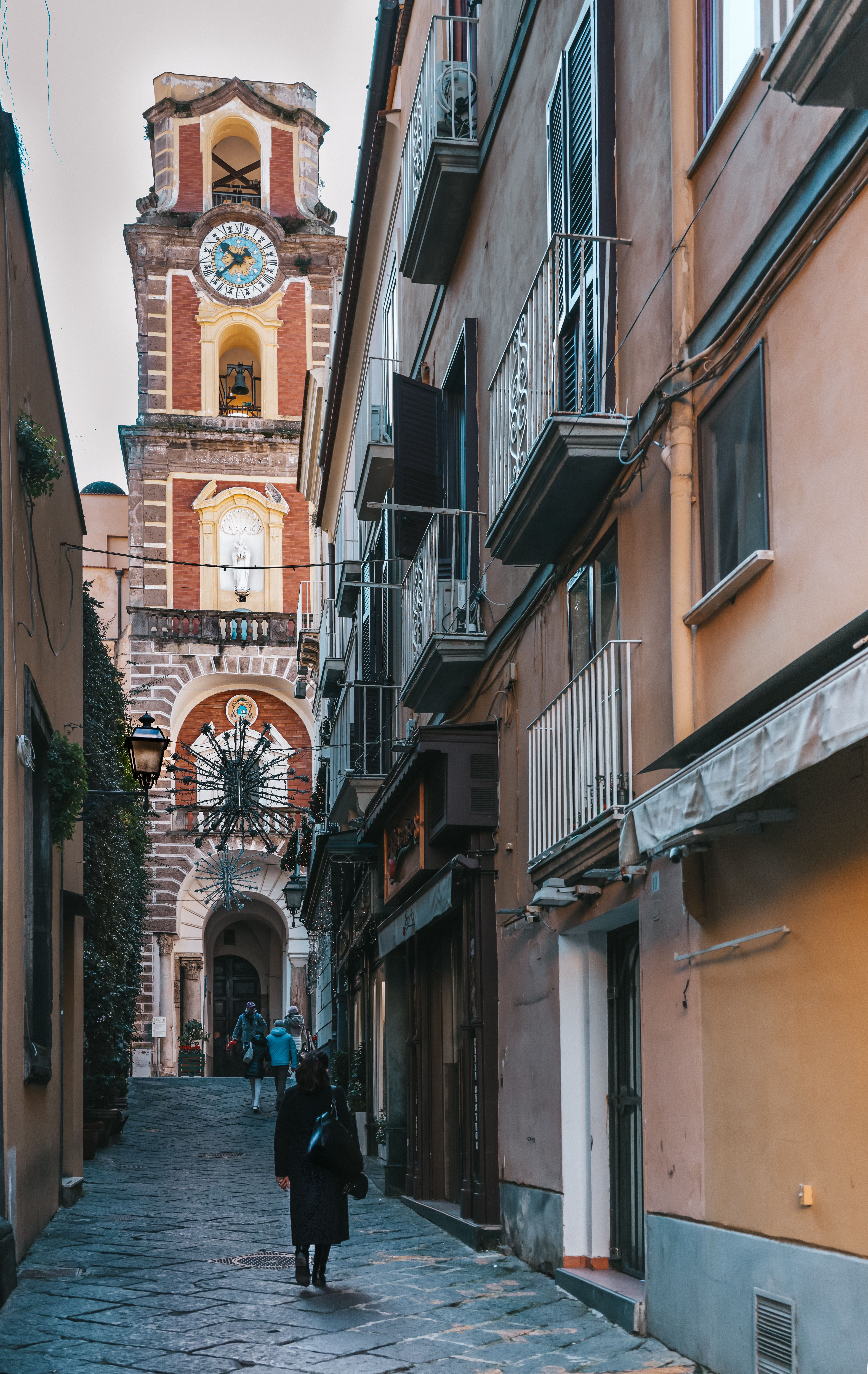 Charming Italian Street with Historic Clock Tower · Free Stock Photo