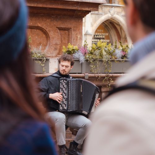 Free A street musician plays accordion in Munich, capturing the essence of Bavarian street culture. Stock Photo