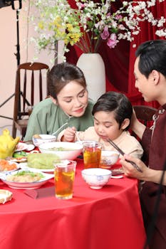 A family shares a joyful meal, highlighting cultural traditions and togetherness.