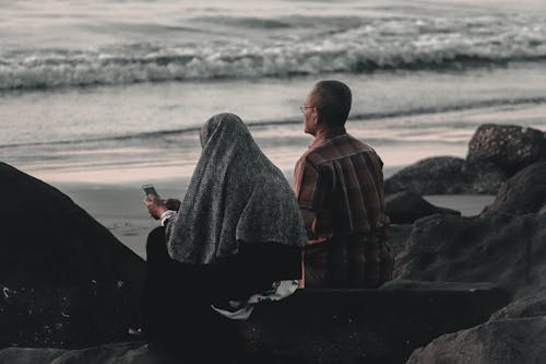 Man and Woman Sitting Rocks 