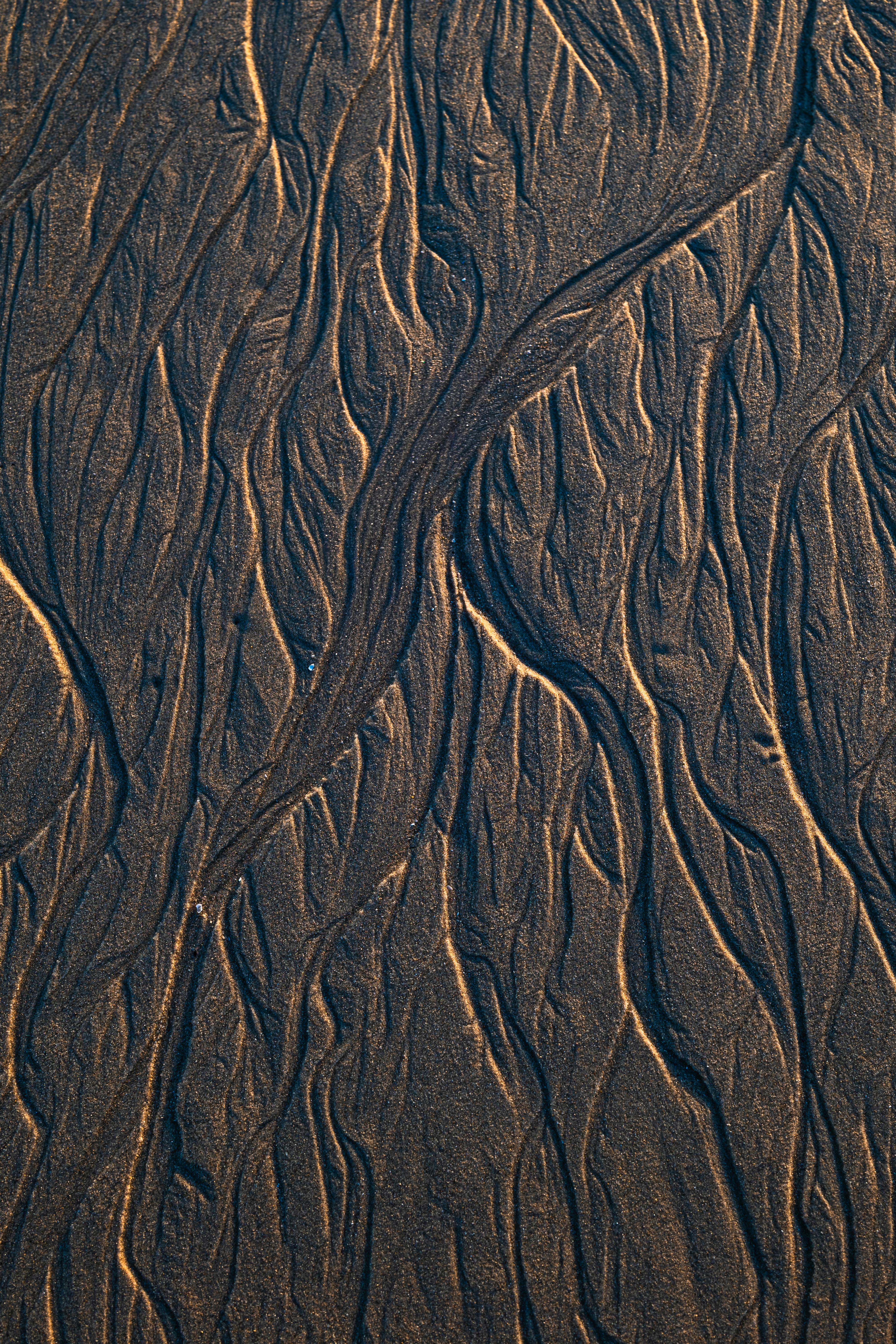 Aerial view of intricate sand patterns formed by wind and water at Al Ahmadi Beach, Kuwait.