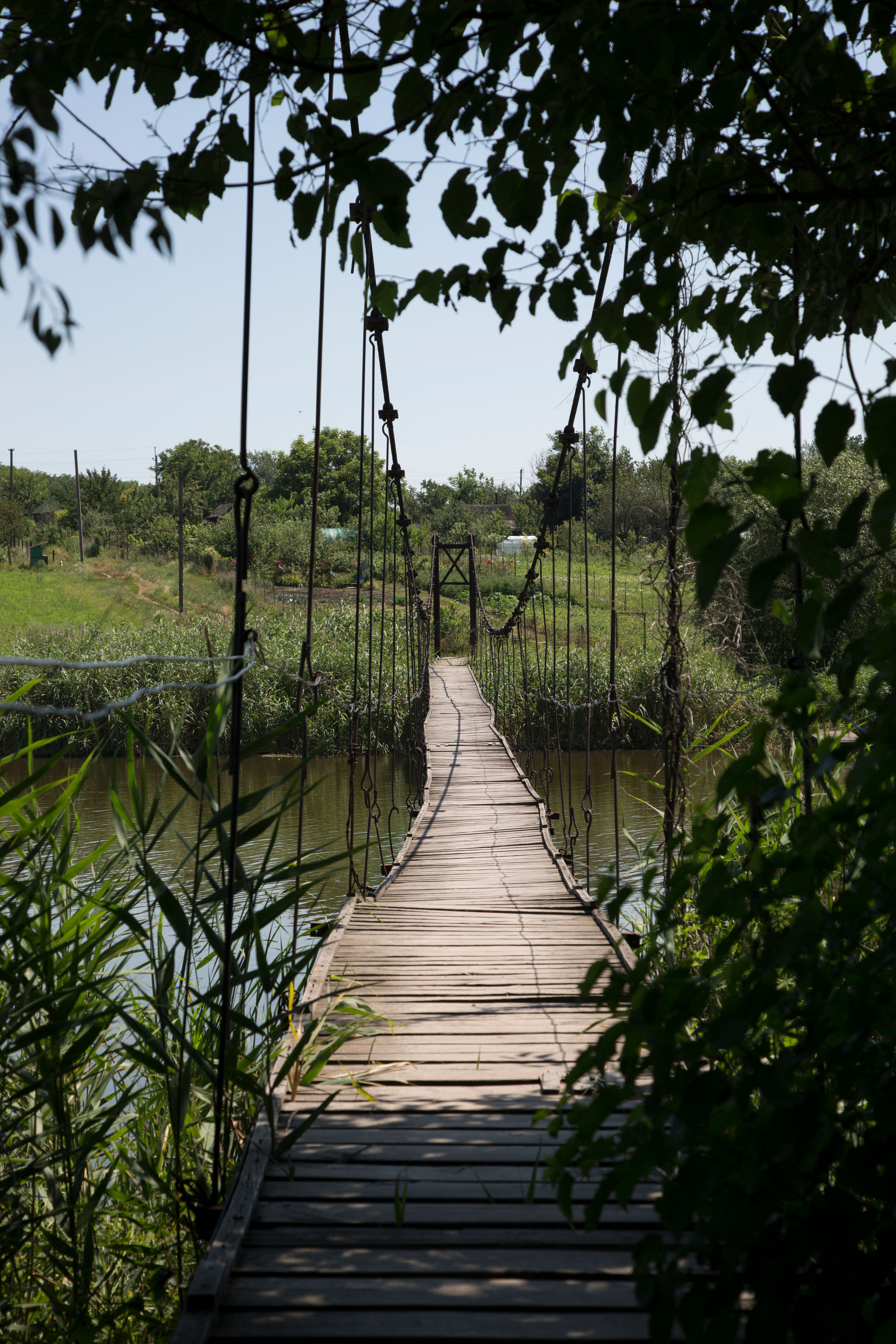 Rustic Wooden Suspension Bridge Over River · Free Stock Photo