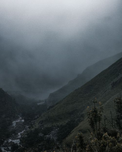 Free Dramatic landscape of wild highland with small river flowing through mountainous valley under thick clouds Stock Photo