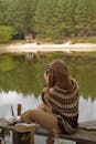 Young Woman Taking Photos by Tranquil Lake