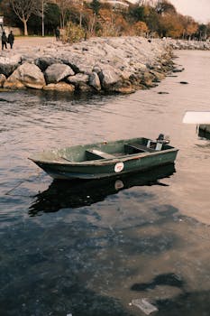 A tranquil scene of a lone boat on Istanbul's Bosphorus with a vintage feel, perfect for travel and lifestyle themes.