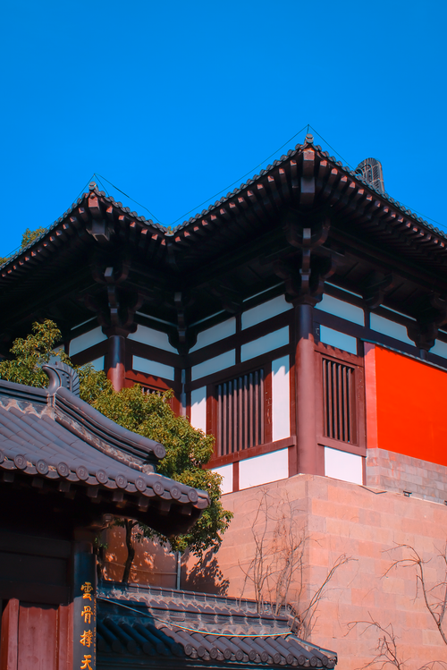 Free Stunning view of traditional Asian temple with vibrant red and brown details against a clear blue sky. Stock Photo