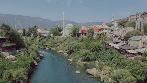 Free Explore the picturesque Neretva River and historic architecture of Mostar, Bosnia and Herzegovina. Stock Photo