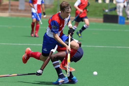 Dynamic field hockey action capturing players in motion during a competitive match.