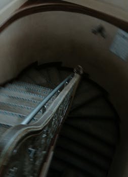 Artistic blurred view of a spiral staircase with decorative railing.