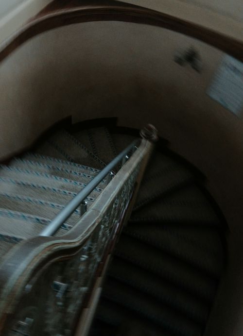 Free Artistic blurred view of a spiral staircase with decorative railing. Stock Photo