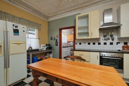 A charming vintage kitchen featuring a rustic wooden table and retro appliances.