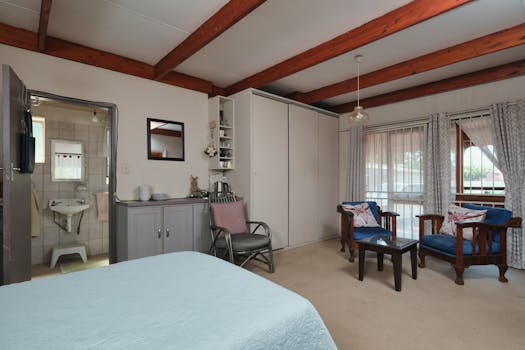 Spacious bedroom design combining comfort and style, featuring a view into the bathroom.