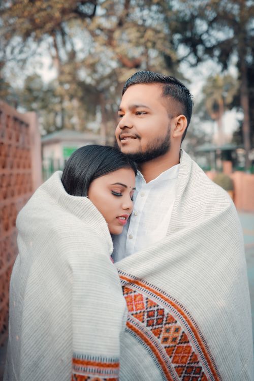 Free A couple warmly embraces under a blanket outdoors, exuding romance and tranquility. Stock Photo