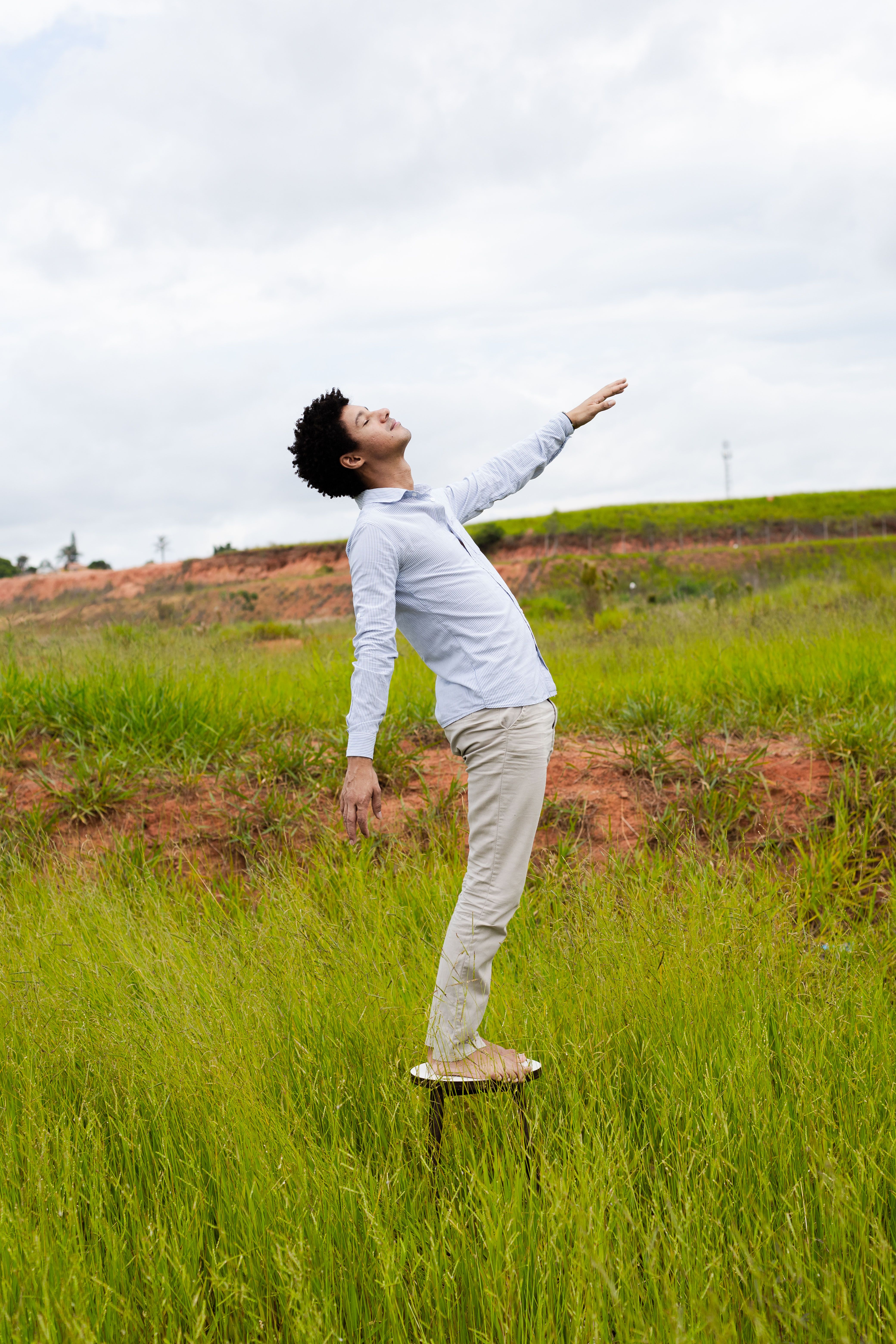 Portrait of a man enjoying nature, standing in a grassy field in São Paulo, Brazil.