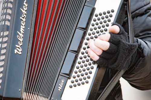 Free Close-up view of a musician playing an accordion on the street in Regensburg, Germany. Stock Photo