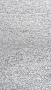 Aerial view of shimmering ocean waves creating abstract patterns.