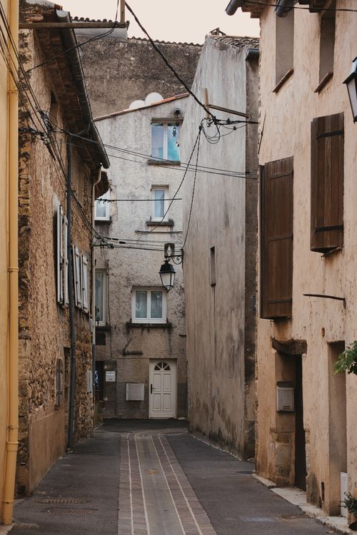 Free Explore the rustic charm of an ancient European alley with stone walls and traditional architecture. Stock Photo