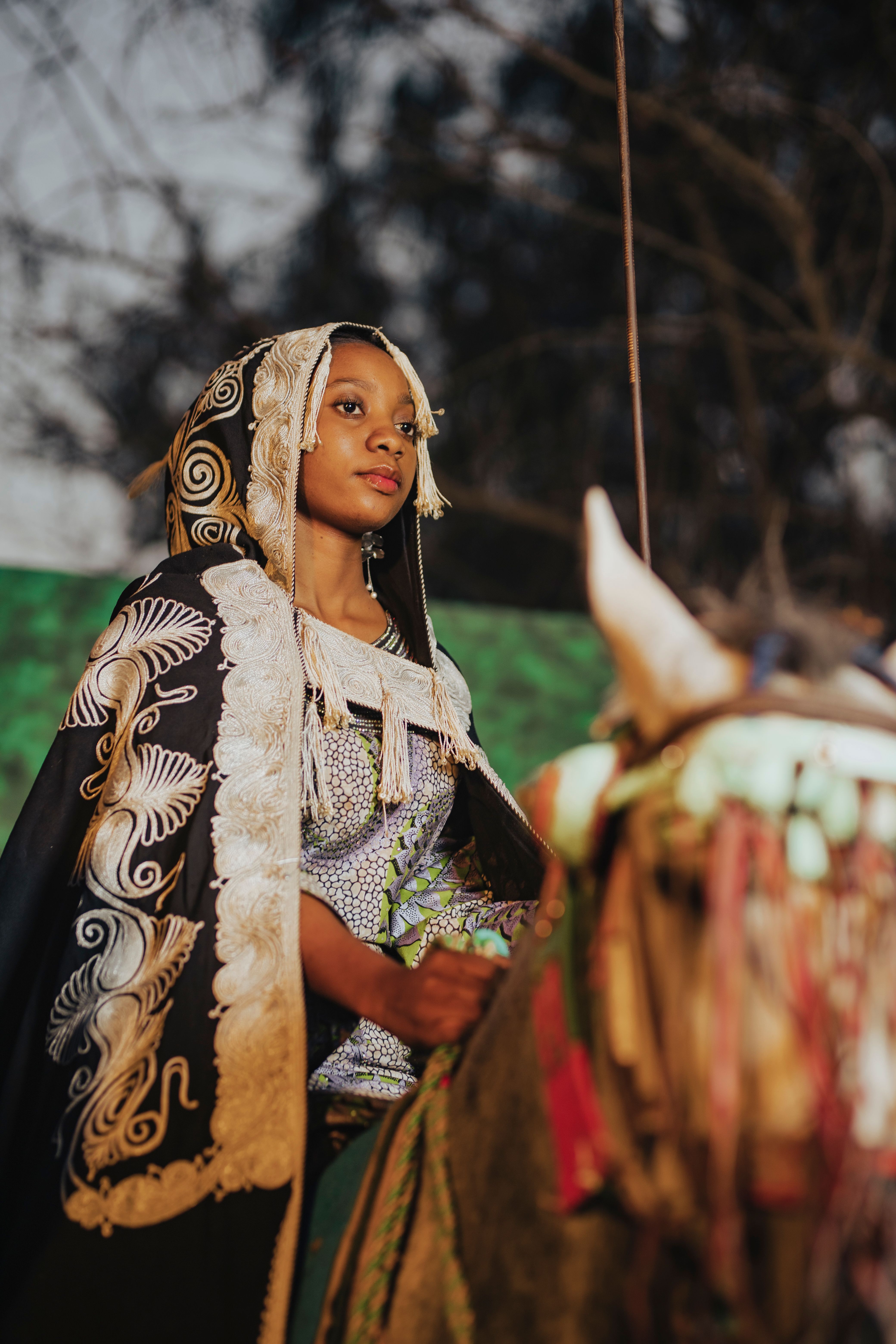 African Woman in Traditional Attire on Horseback · Free Stock Photo