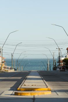 A serene street in Mar del Plata leading to the ocean, perfect for travel and nature scenes.