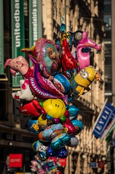Vibrant balloons in Helsinki during a lively street festival, capturing the joyful atmosphere.