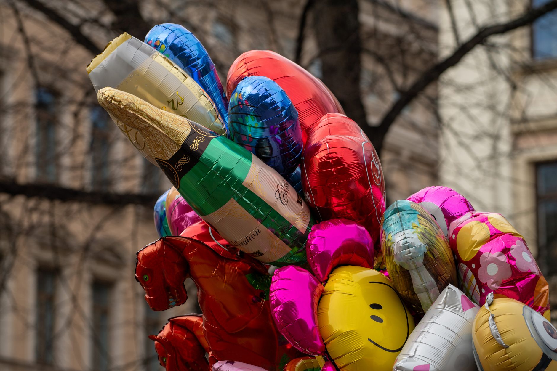 A cluster of vibrant balloons in an urban setting, perfect for festive occasions.