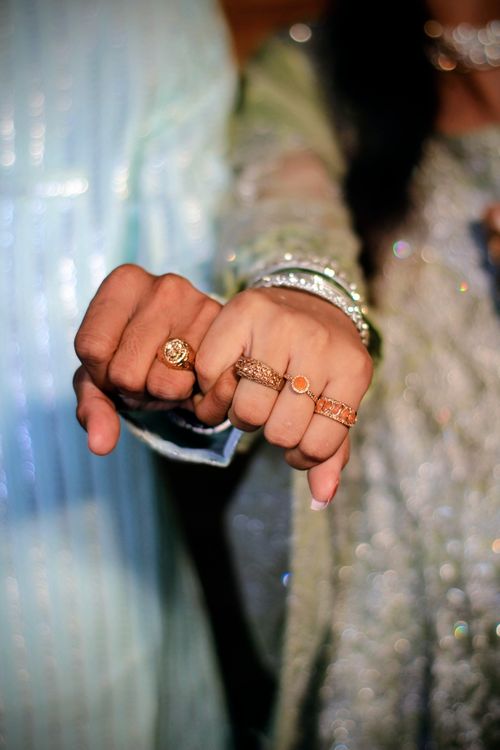 Free Close-up of a couple's hands showcasing traditional rings at a Pakistani wedding. Stock Photo