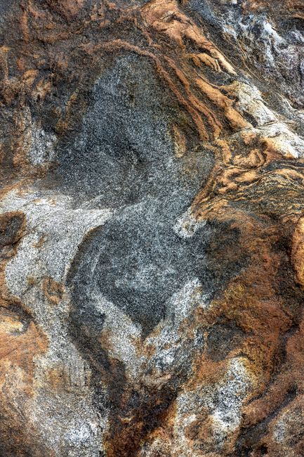 Close-up of natural stone texture showcasing earthy tones, perfect for backgrounds.