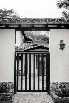 Elegant colonial gate leading to a traditional house in Antioquia, Colombia.
