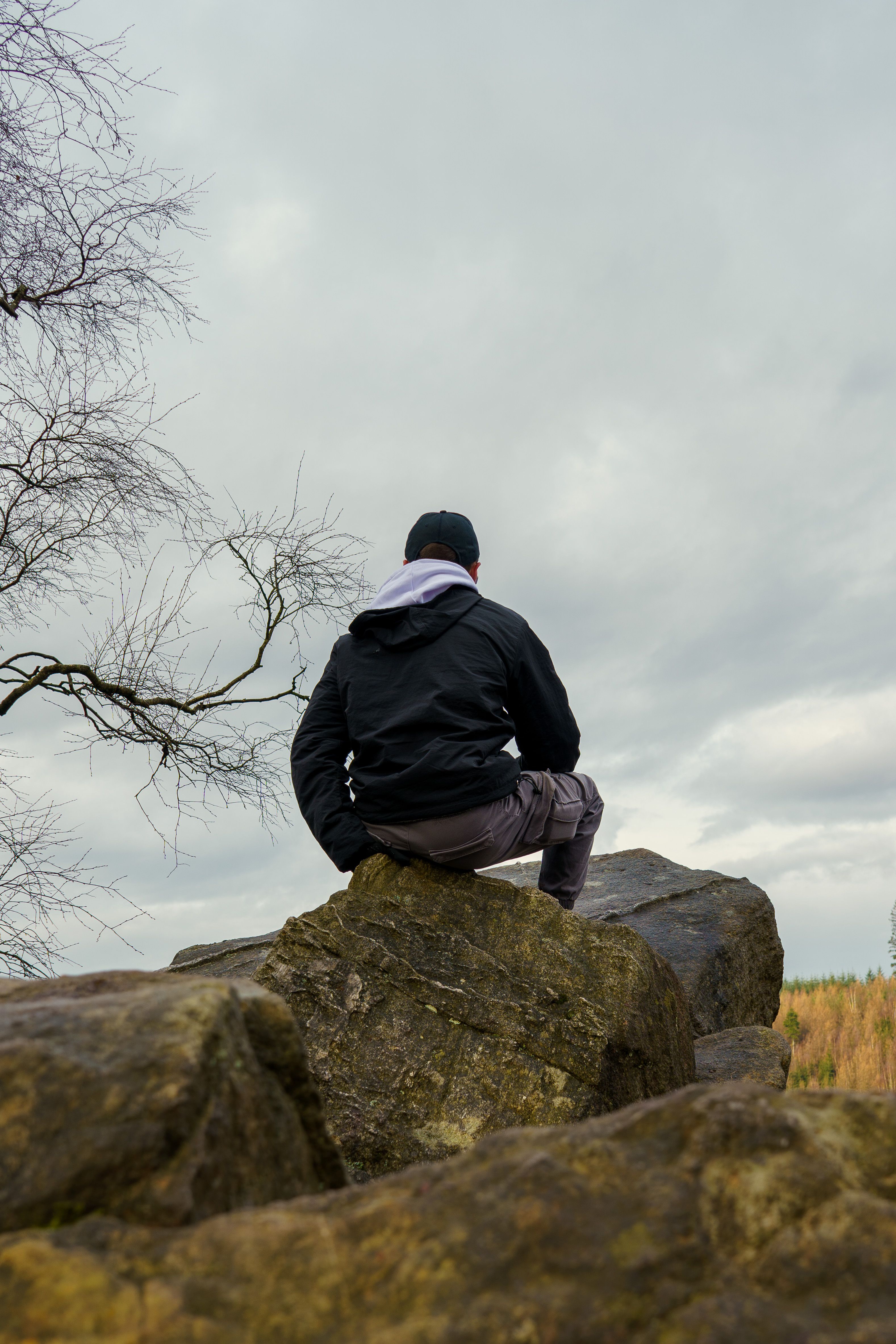 Person Sitting on Rocks in Nature, Malmedy · Free Stock Photo