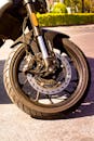 Close-up of Motorcycle Front Wheel on Sunny Day