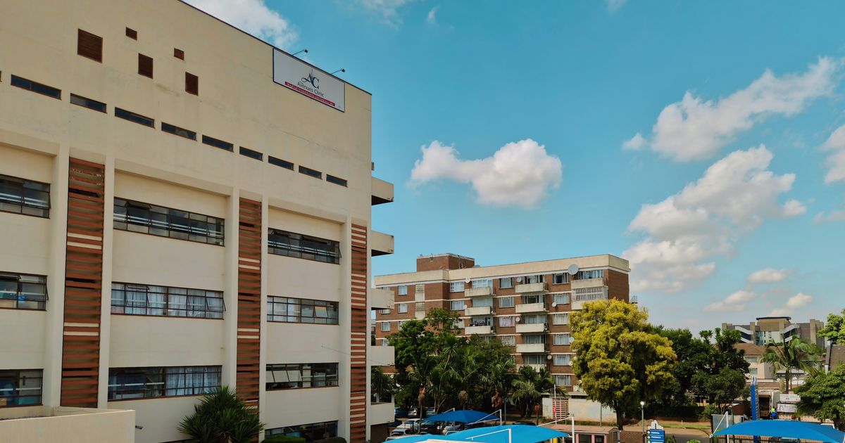 Modern clinic building with blue sky and urban setting