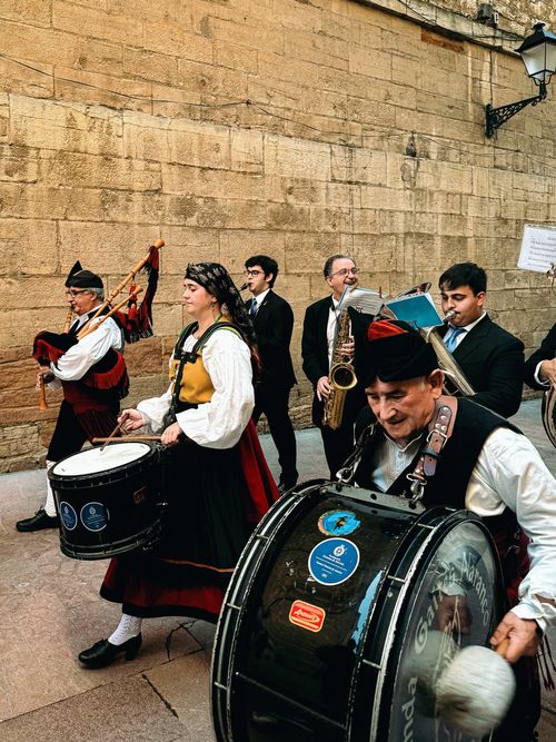 Free Musicians in traditional attire performing during a parade in Oviedo, Spain. Stock Photo