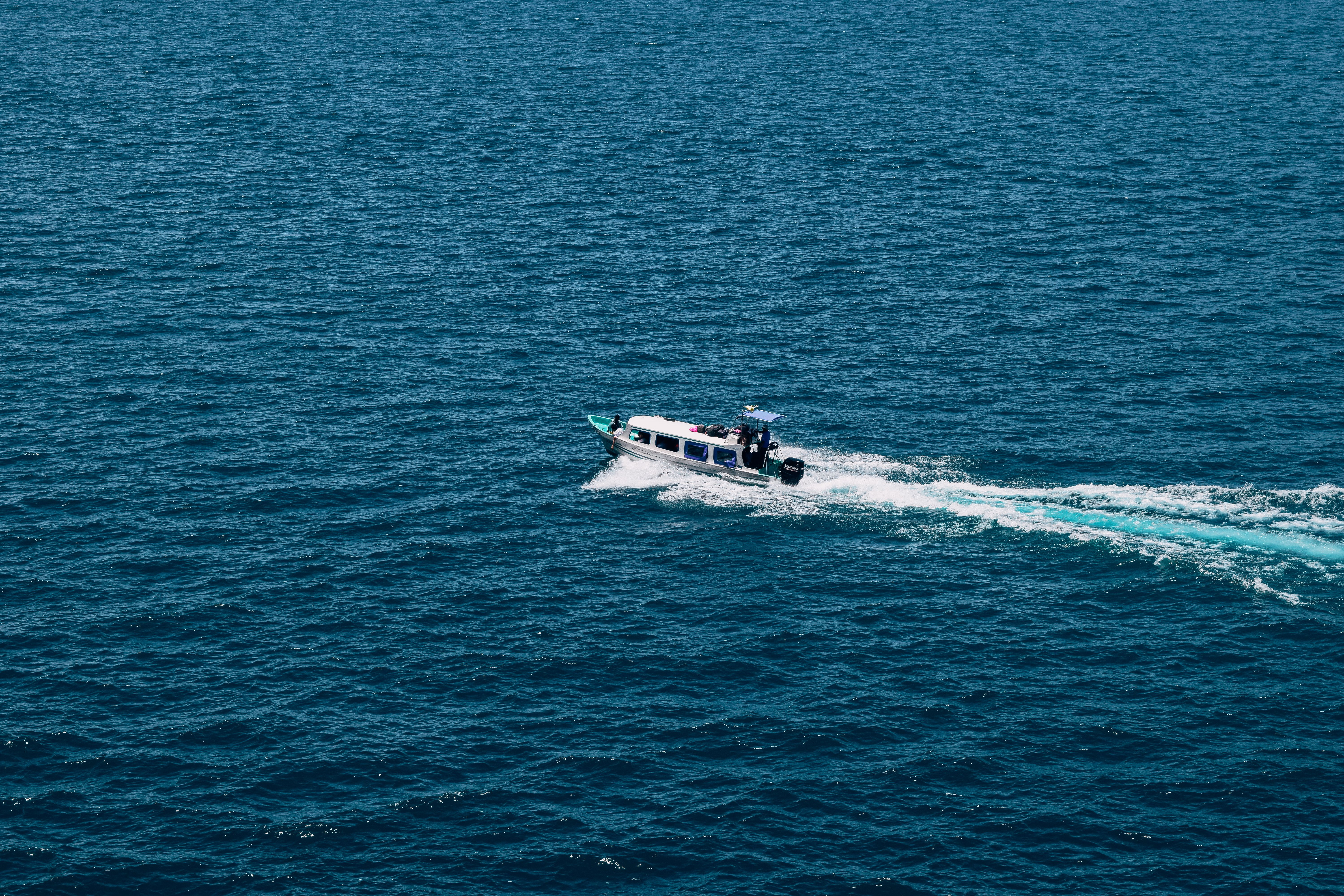 A sleek speedboat speeding across the calm, blue waters of the Maldives, transporting guests to an island resort