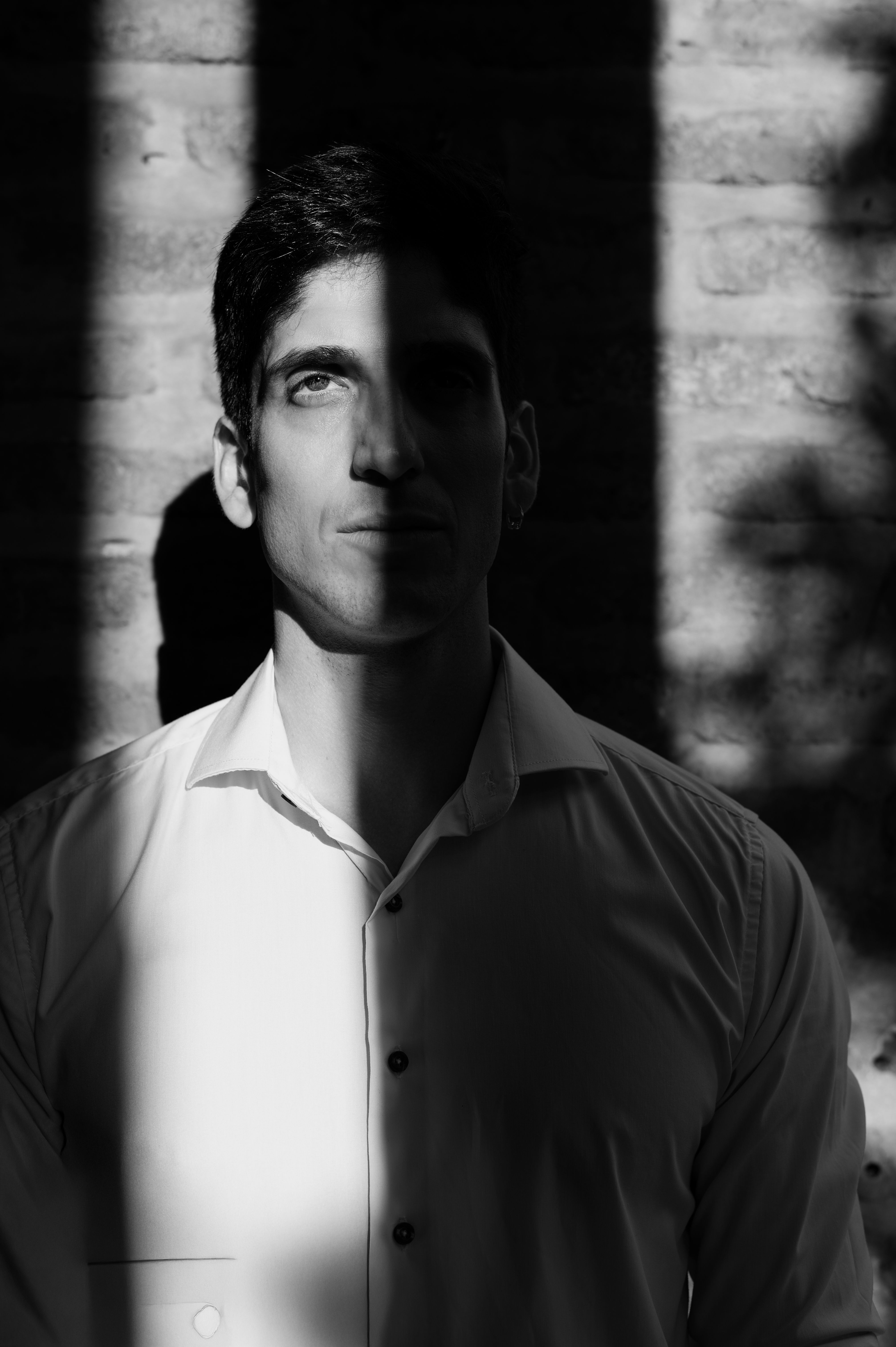Moody black and white portrait with strong shadows in Buenos Aires, Argentina.