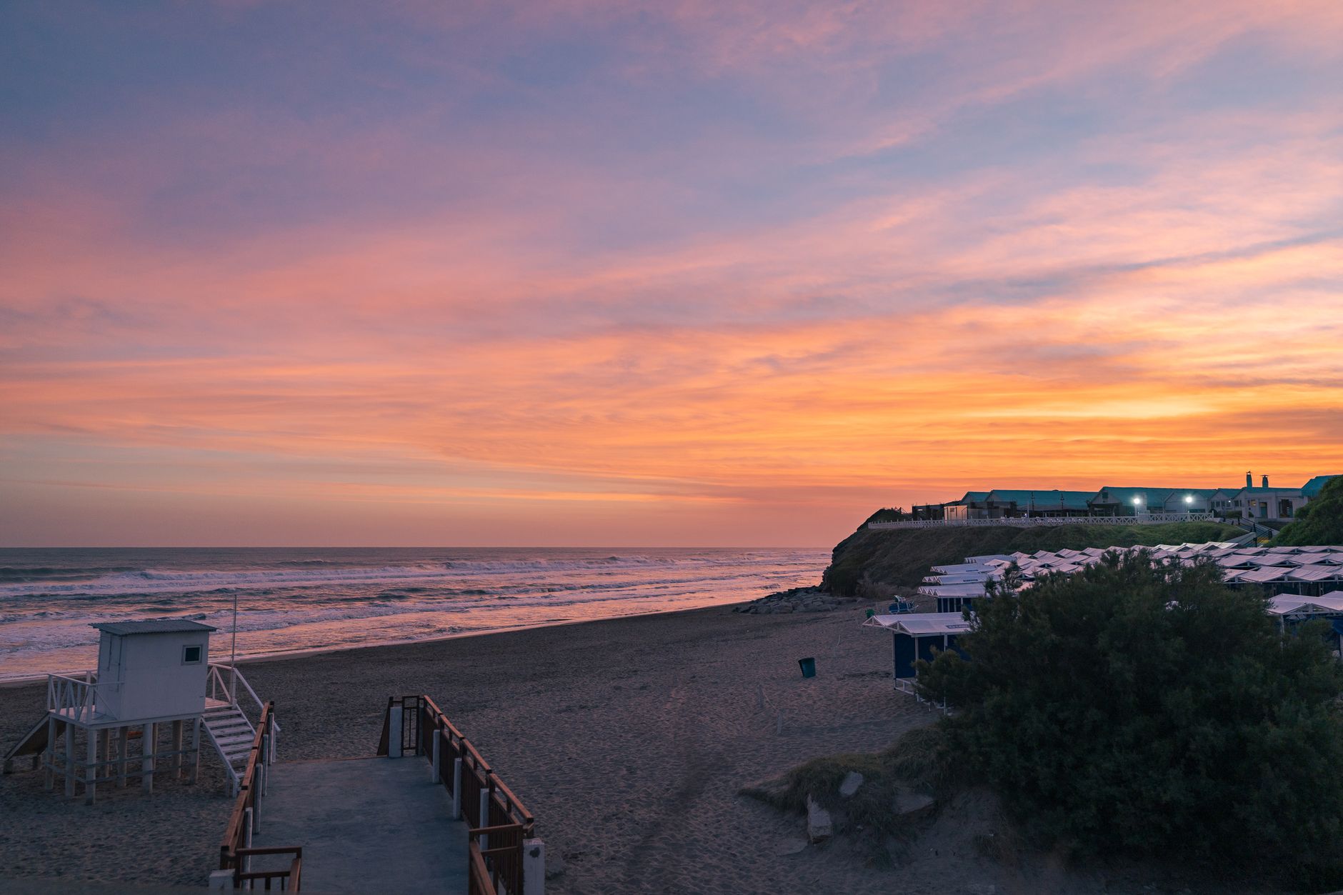 Stunning sunset over Mar del Plata beach, Argentina, with colorful skies and calming waves.