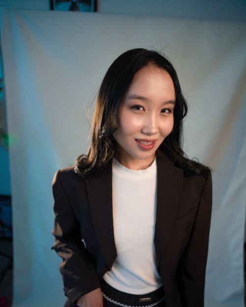 Free A young adult woman poses confidently in a stylish outfit indoors. Stock Photo