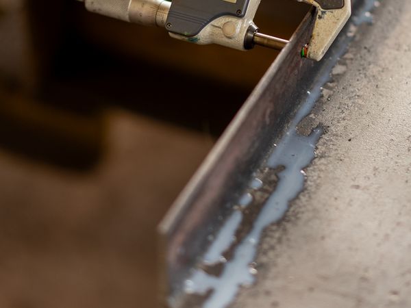 Digital micrometer measuring the thickness of a metal part for precision verification
