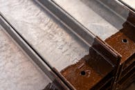 Close-Up of Rusty Metal Rails in Industrial Setting