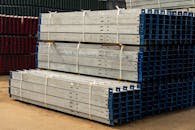 Stacked Metal Beams in Industrial Yard