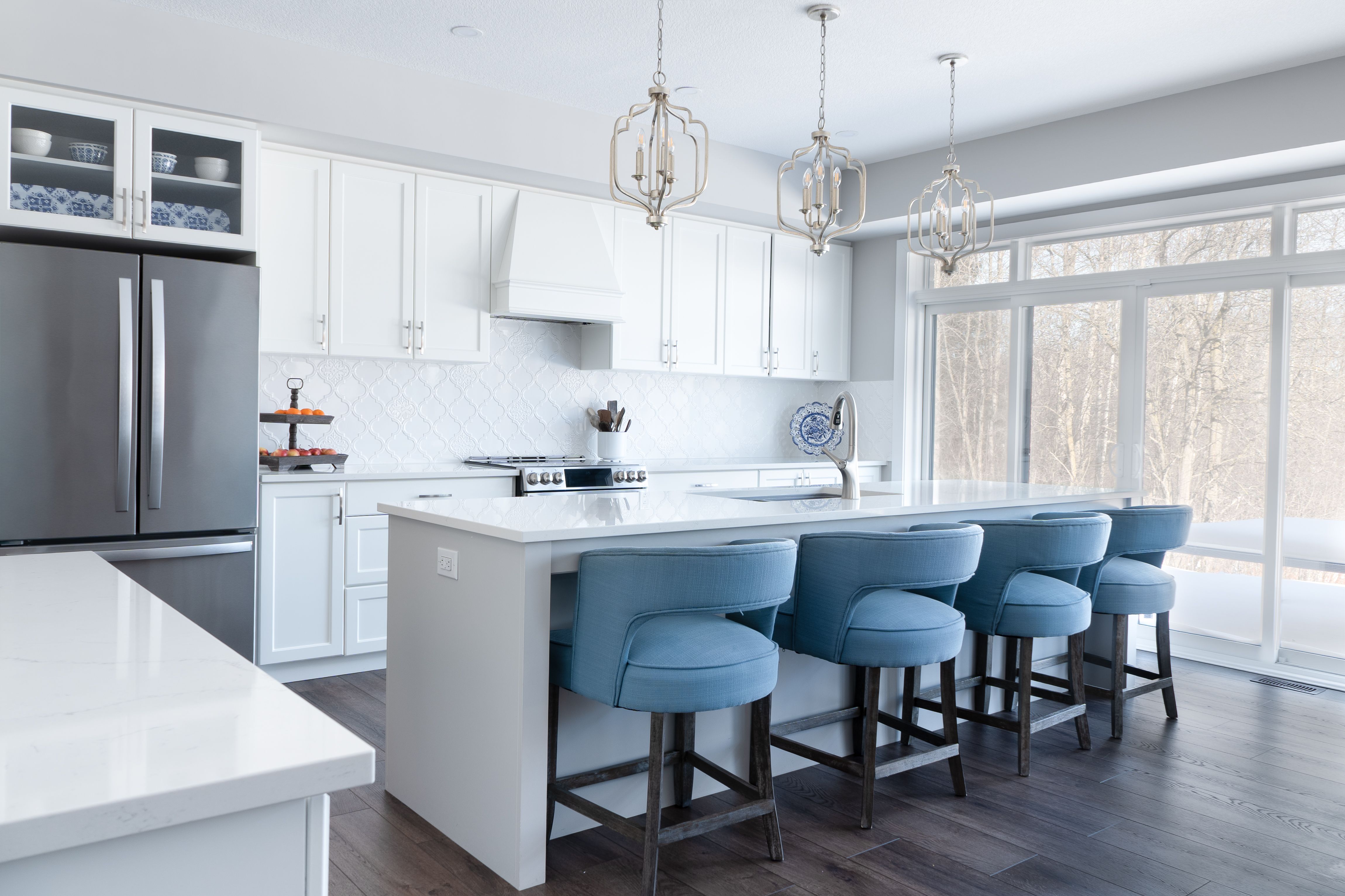 An island with a seating overhang and stools tucked under
