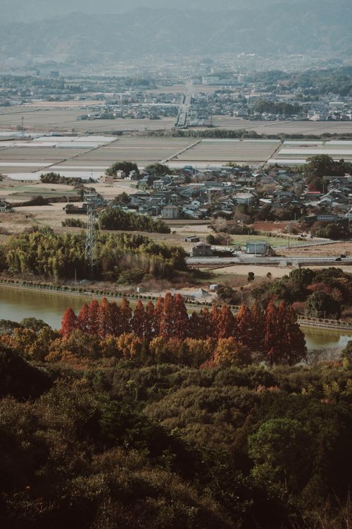 Free A scenic view showcasing a rural landscape with vibrant autumn foliage and distant fields. Stock Photo