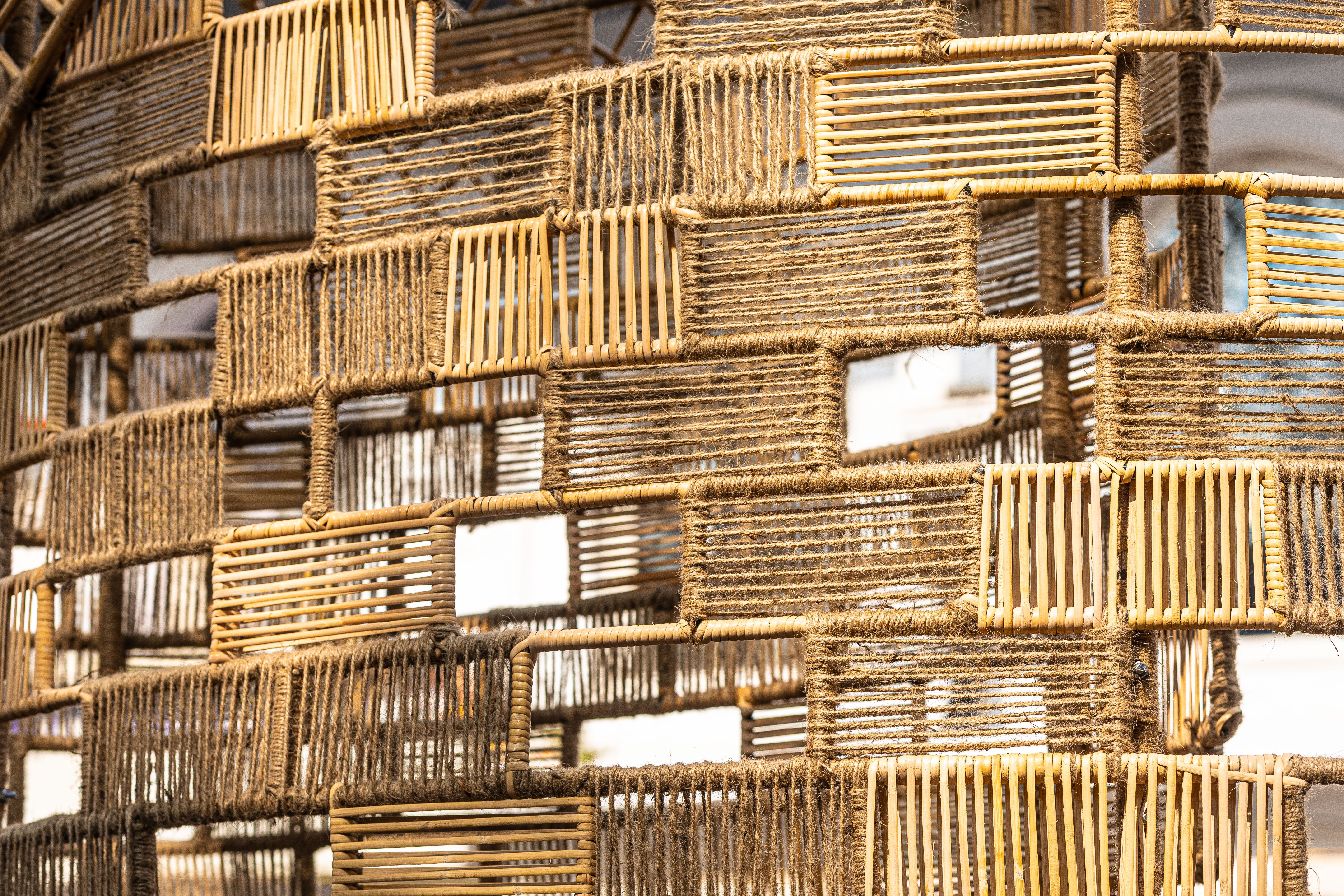 Detailed view of a handcrafted bamboo and jute weaving structure showcasing traditional craftsmanship.