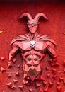 Red Abstract Sculpture of Armored Figure
