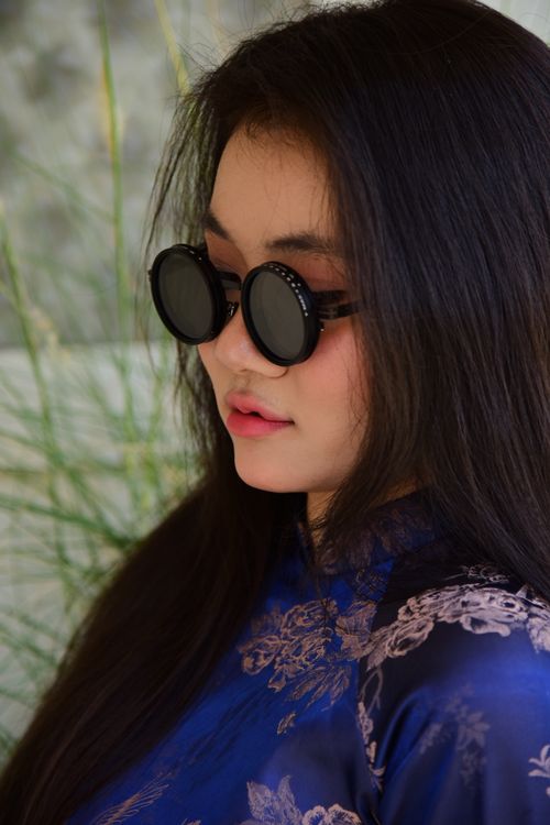 Free Woman in stylish sunglasses and traditional dress with long hair outdoors. Stock Photo