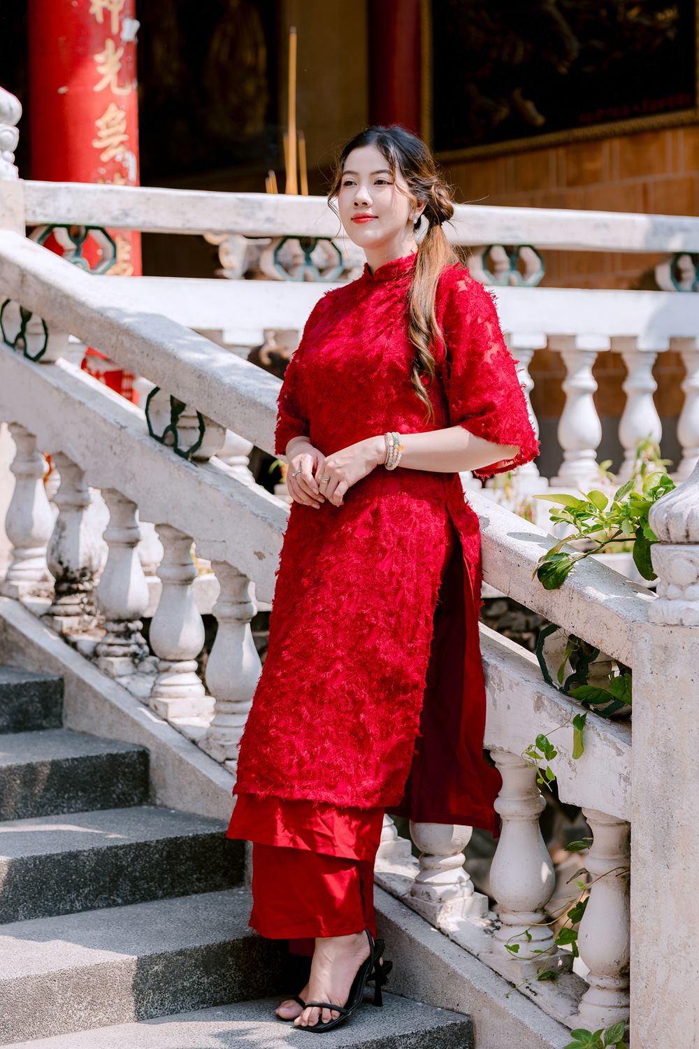 Elegant Woman in Traditional Red Dress on Staircase · Free Stock Photo