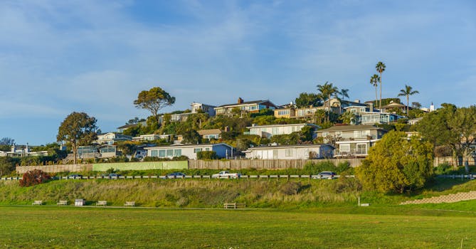 Beautiful hillside neighborhood with modern homes under a clear sky in California.